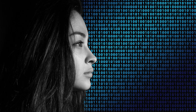 the profile of a woman on top of binary code